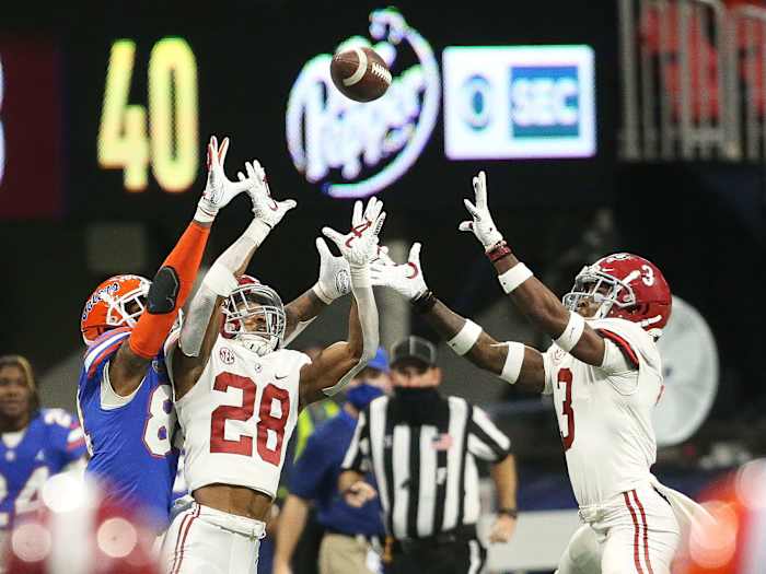 Alabama and Florida players both leap for a pass in the 2020 SEC title game
